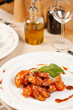 portion of sesame chicken served on a white plate