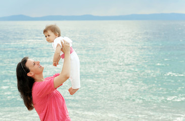 Fototapeta na wymiar Mother with her baby at beach