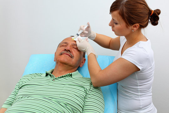 Older men receiving botox injection