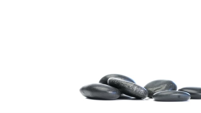 Rotating pile of black pebbles falling