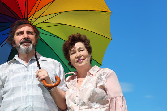 Portrait Of Old Woman And Man Holding Umbrella