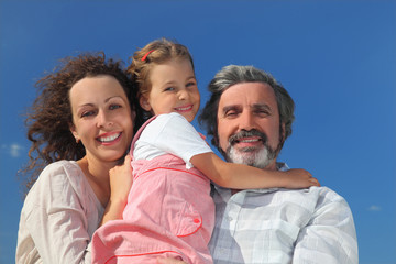 family with girl, mother and grandfather smiling