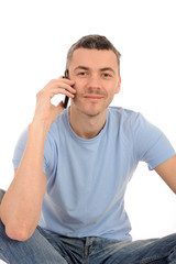 casual young man with cell phone and headphones. isolated