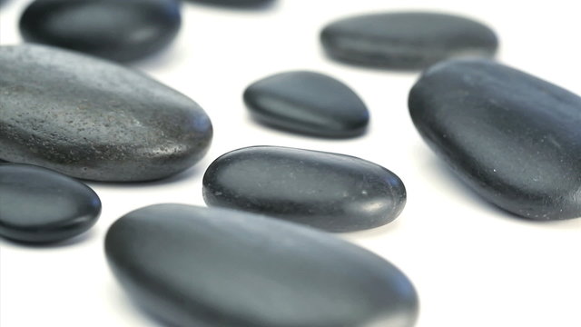 Black pebbles turning on themselves