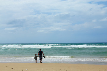 Father and son on the beach in spring time