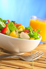 Chicken salad with lettuce, mango, bell pepper and cucumber