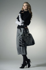 young fashion model posing in light background in the studio