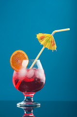 red coctail drink with ice cubs
