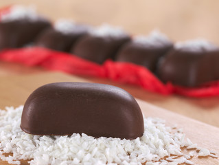 Chocolate candy on grated coconut
