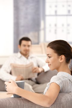 Young couple sitting in living room at home