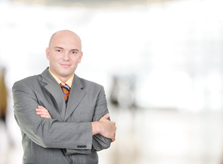 Young, balded head businessman with folded hands