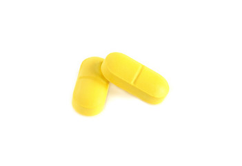 two close-up isolated yellow pills, tablets