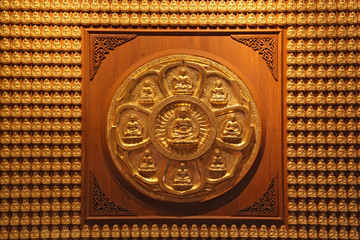 golden wheel of buddha on wall in dragon temple Thailand