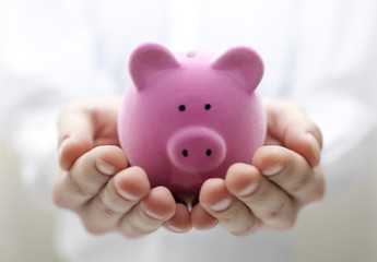 Man holding piggy bank. Shallow DOF