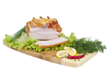 Ham with herbs and spices on a blackboard, isolated on a white b