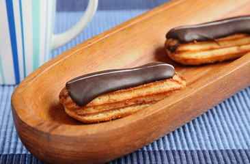 Eclairs on blue table cloth