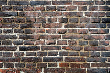 Rough aged wall made of flamed bricks