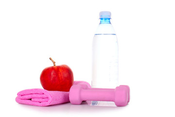 Blue bottle of water, apple and exercise equipment isolated agai