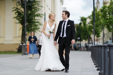 Bride and groom walking in a town