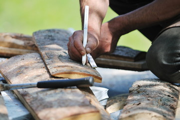 wood worker with chainshaw closeup