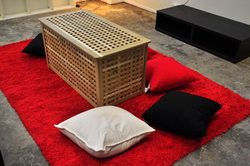 table, pillow and carpet on the floor