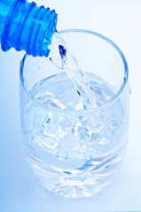 bottle pouring water into  glass