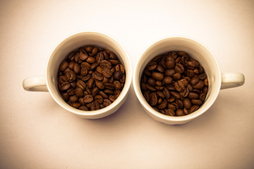 two cups with coffee beans