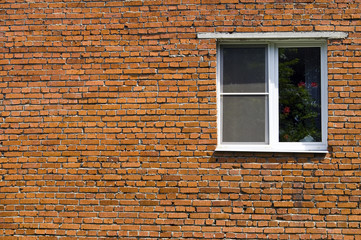 Window at the brick wall of the house
