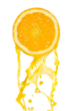 orange juice splashing from cut fruit, isolated