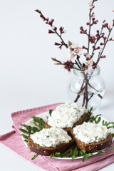 Cheese snack on rye bread and a bouquet
