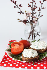 Cheese snack on rye bread and a bouquet