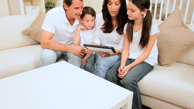Attractive Caucasian Family at Home Using a Wireless Tablet