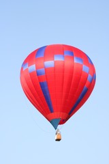 Red and blue hot air balloon flying