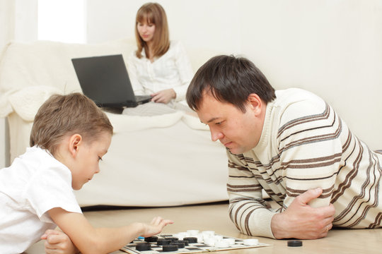 Father With The Son Playing Draughts