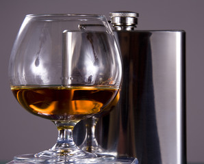 Glass with cognac and Flask
