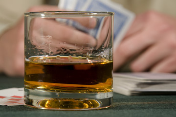 Glass with cognac and playing cards