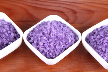 Obraz na płótnie Canvas Lavender spa salt in white bowls on a wooden background