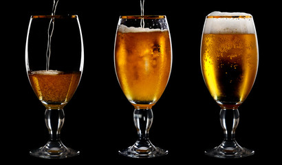 Beer into glass on a black