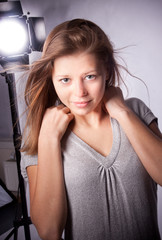 Obraz na płótnie Canvas caucasian blonde model posing in studio behind big flash