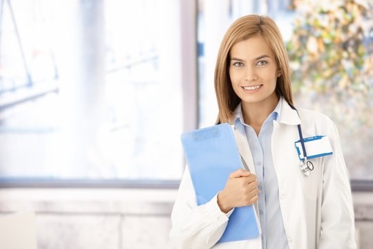 Young medical student smiling in office