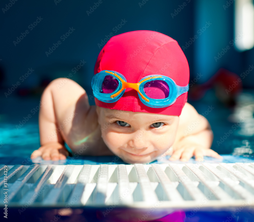 Wall mural child in a swimming pool