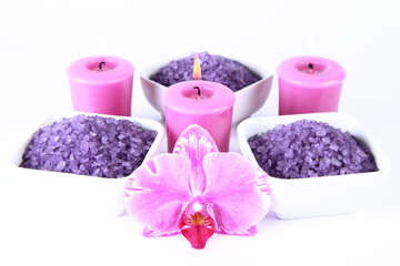 Fototapeta na wymiar Lavender spa salt, candles and an orchid flower on white