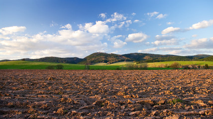 Rural view with plowed field in hills