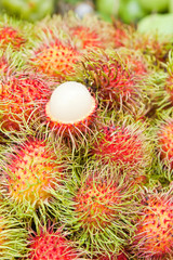 Tropical Fruit,white pulp rambutan among red rambutan.