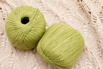 two green yarn skeins on the cloth