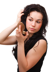 Obraz premium Girl is looking at herself in mirror