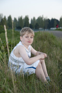 Portrait of young boy backlit against beautiful setting sun