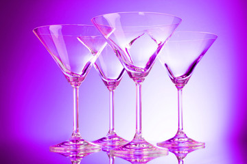 empty glasses of martini on purple background