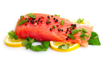 Red fish with pepper and green leaves isolated on white