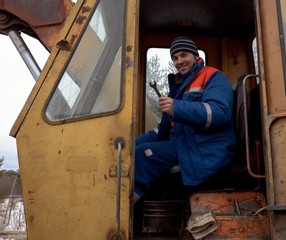 Machinist excavator with a wrench in his hand